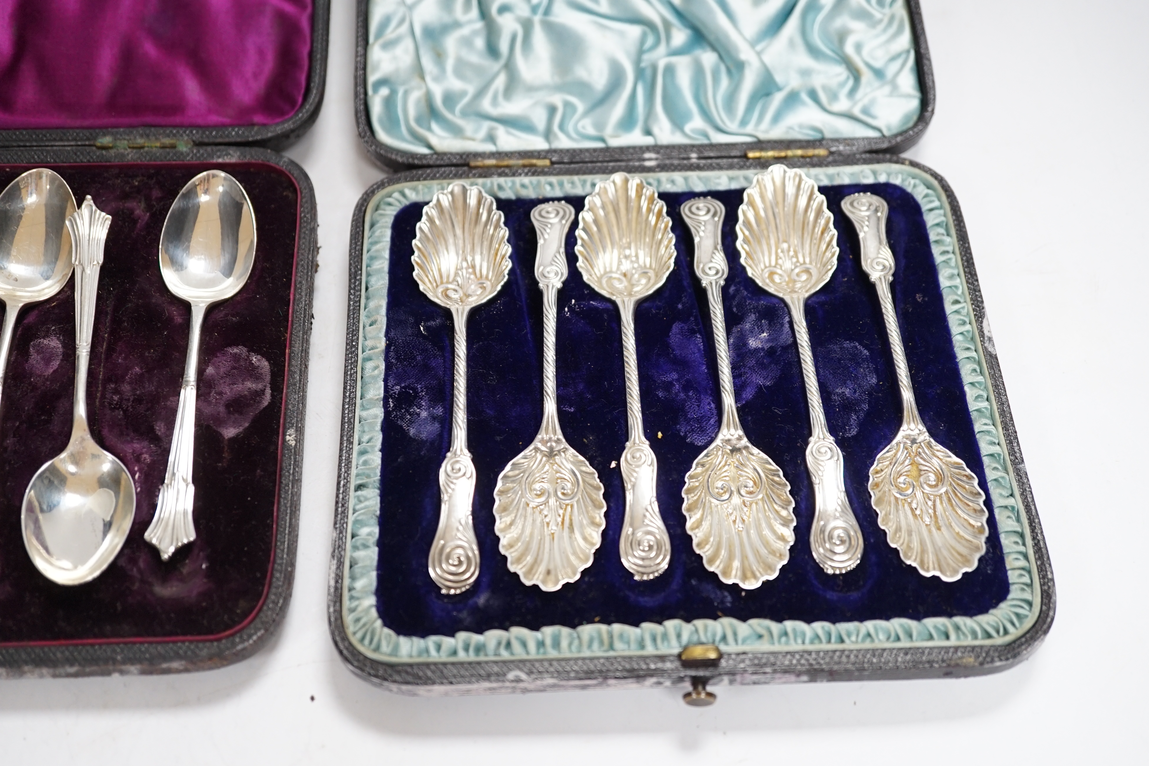 A cased set of six late Victorian silver teaspoons, Mappin & Webb, Sheffield, 1893 and one other later similar cased set with sugar tongs.
